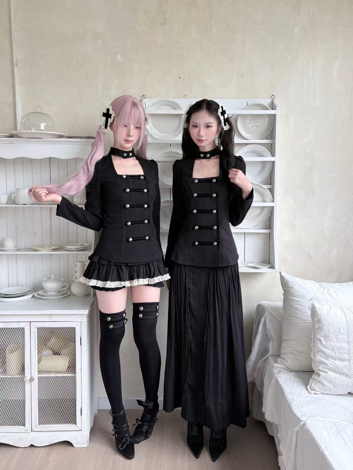 Two models wearing coordinated gothic black outfits