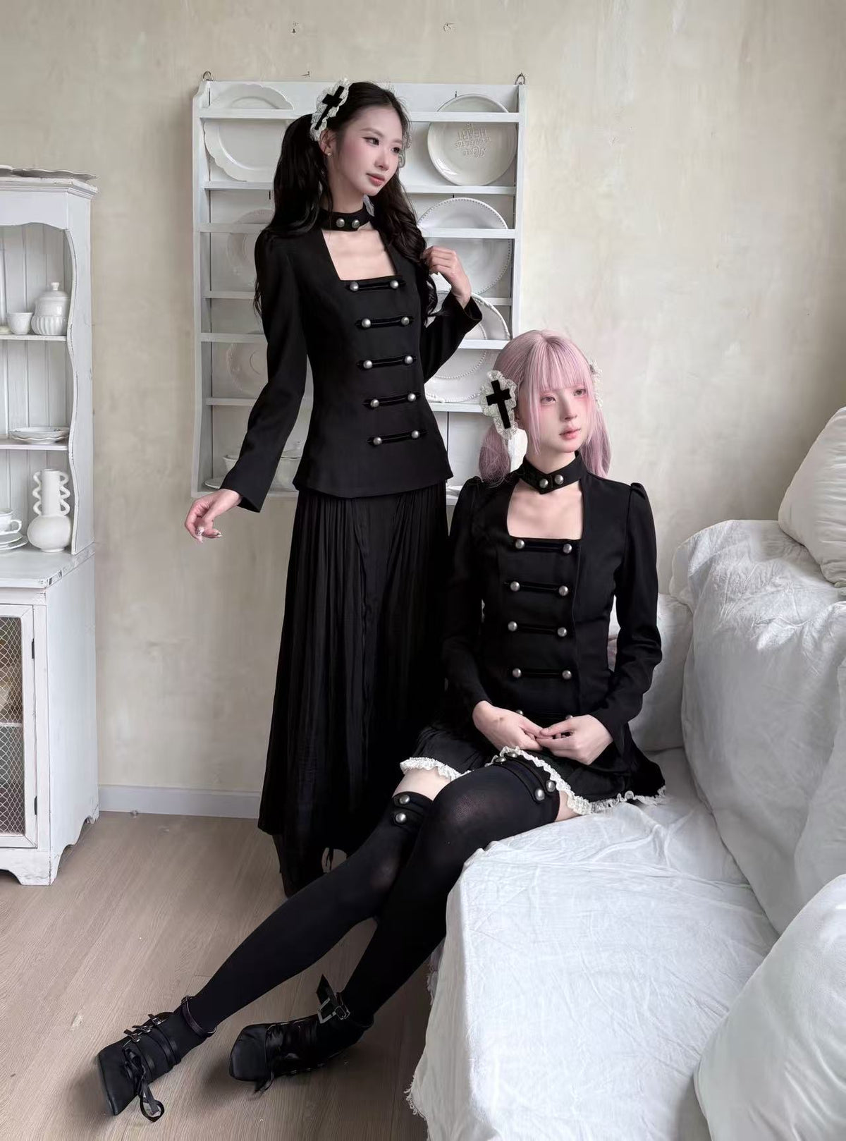 Two models styling long black gothic outfits