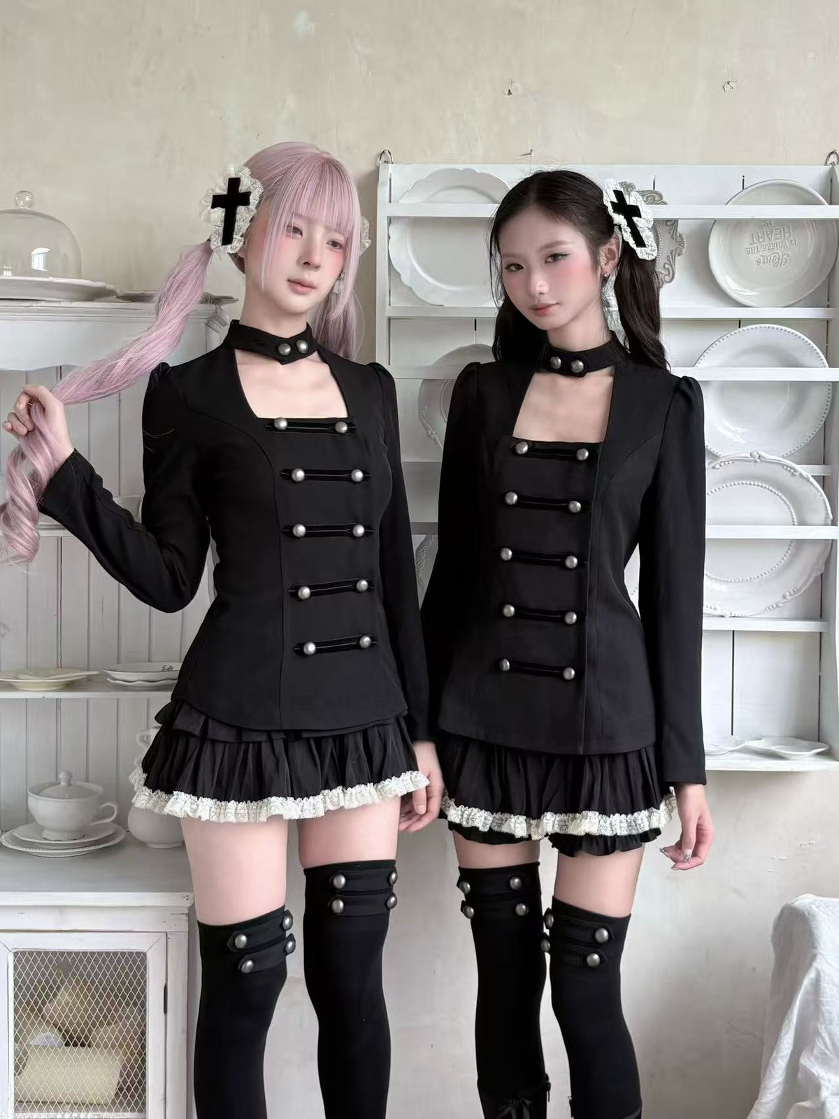 Two models wearing black gothic alternative outfits
